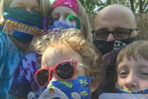Photo of family of five wearing masks