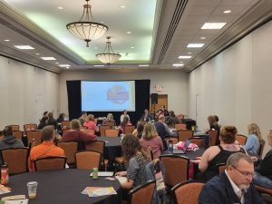 A crowded breakout room at the autism conference