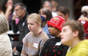 A photo of a crowd watching a session at the Autistic Community Summit