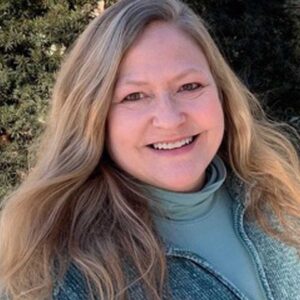 Jenny Dempsey Austin - A white woman with long blond hair who is smiling.